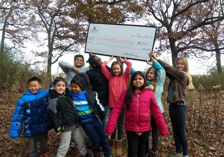 Kids hold up grant check. Photo by Groundswell Conservancy