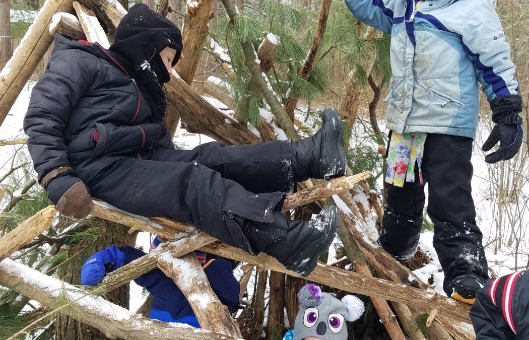 Children build a fort in the winter.