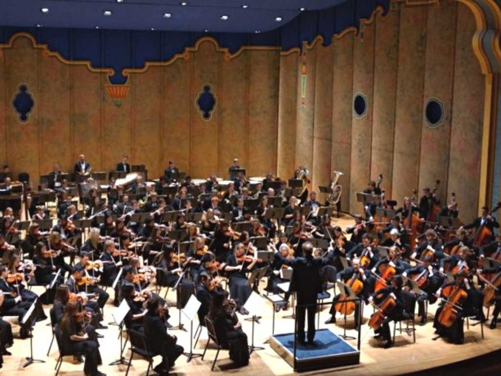 An orchestra performs on a stage