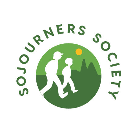 SojournersSociety Color Sojourners Society logo: two peoples' silhouettes walking with abstract trees and a sun behind them