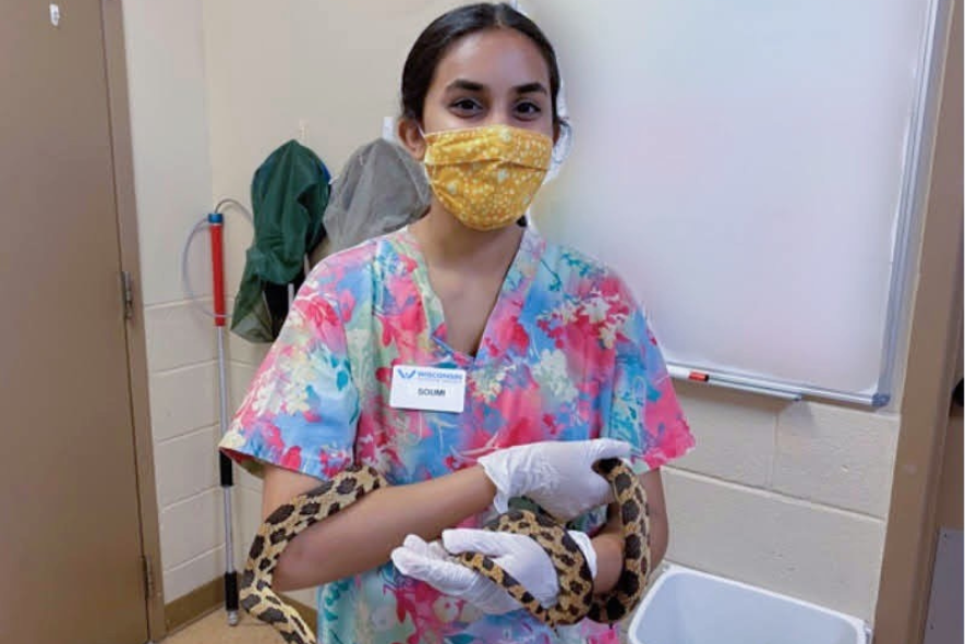 Soumi holding a snake at the Wisconsin Humane Society Wildlife Center in Milwaukee