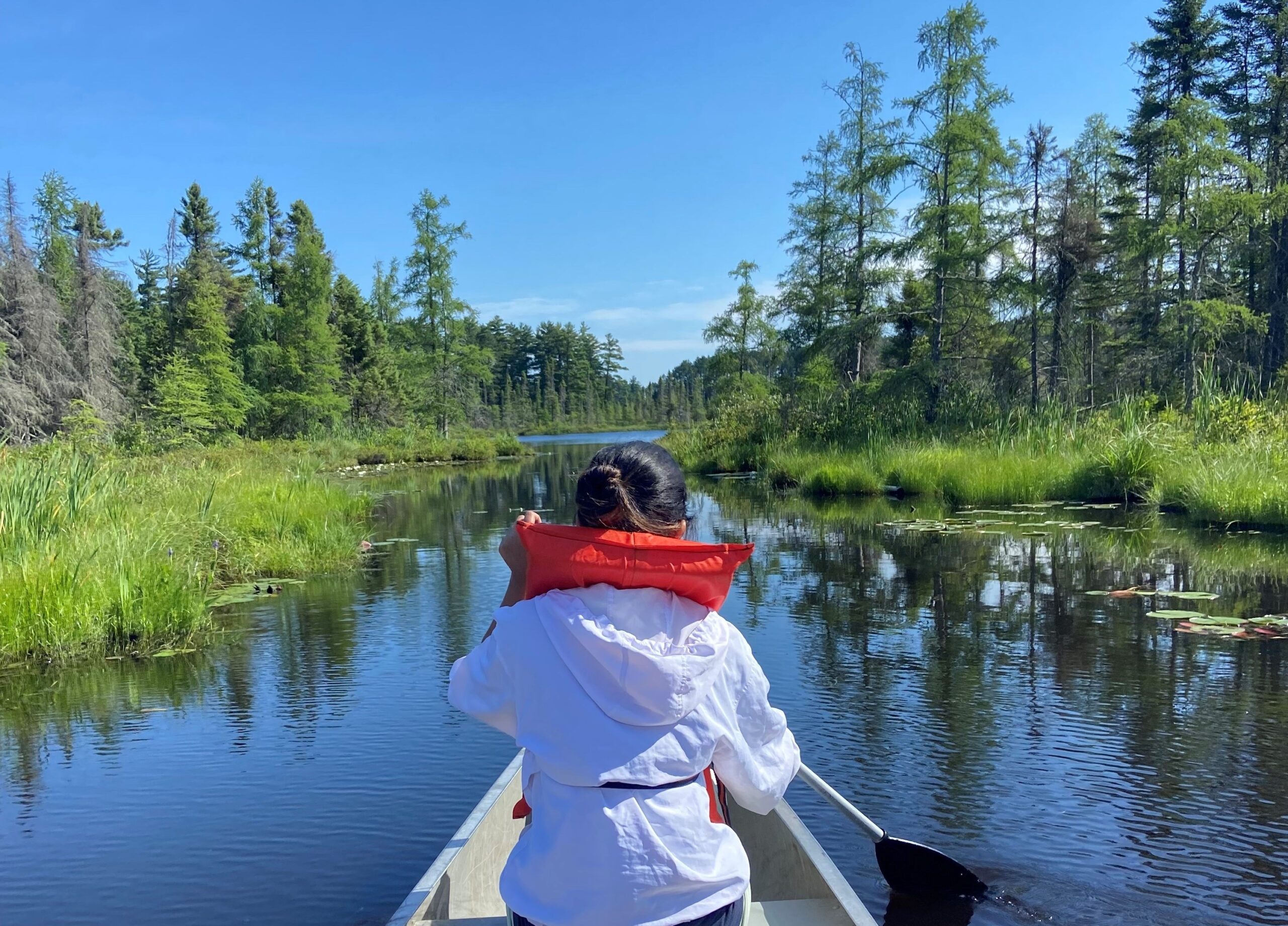 Soumi in a canoe at Kemp Natural Resources Station during a weekend retreat for the NRF Diversity in Conservation internship.