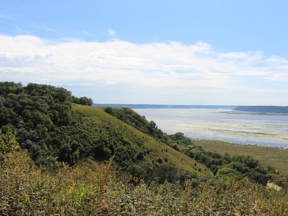 Landscape view of Rush Creek State Natural Area cliffside with body of water in the background