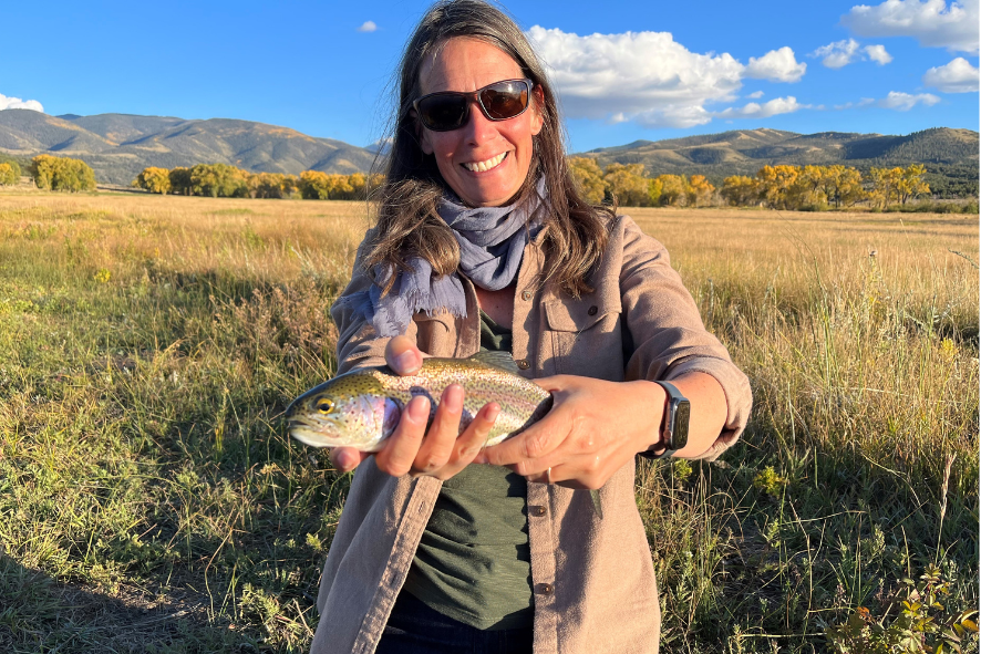 Christine holds a trout she caught while fly fishing in Colorado.