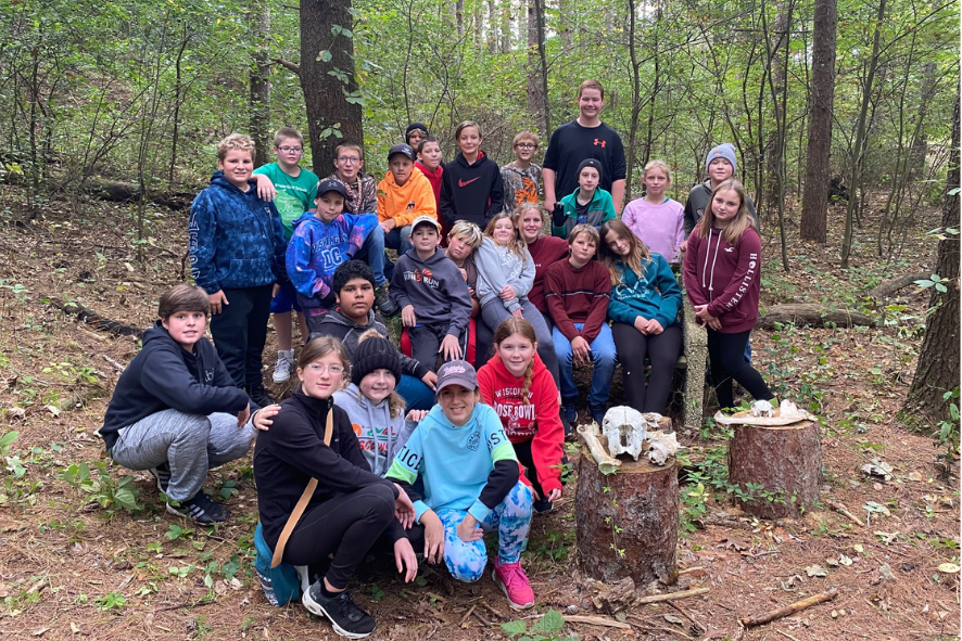 Group photo of kids outside in the woods, photo for diversity in the outdoors blog