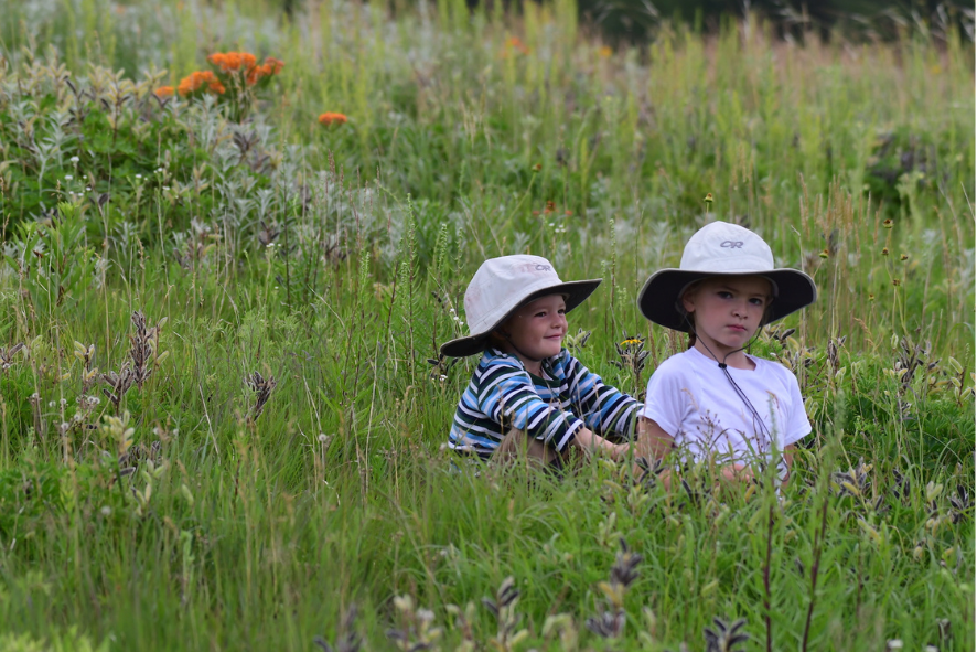 Two children sitting in a prairie