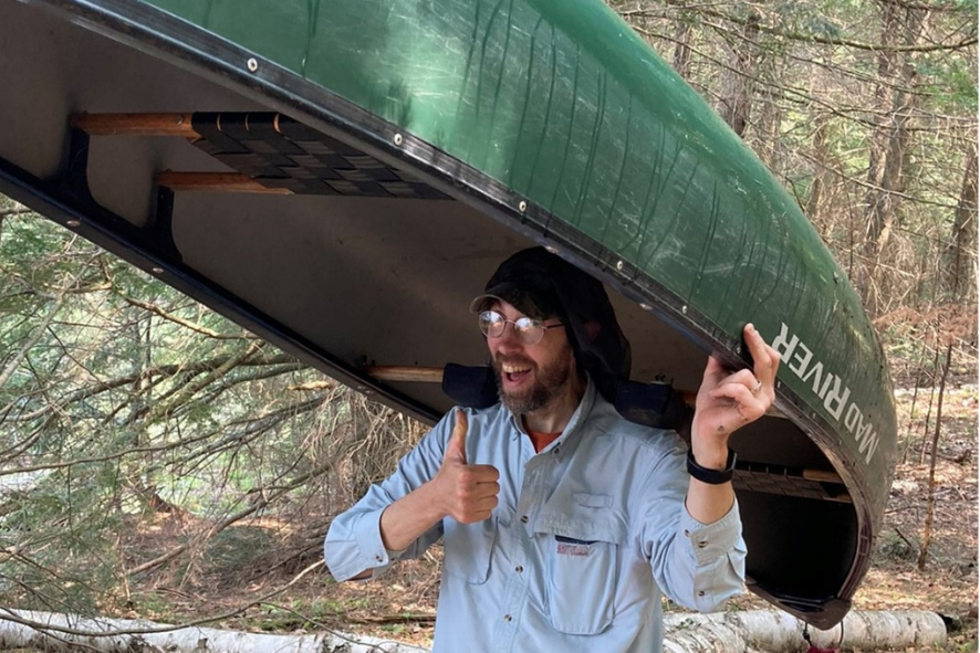 Troy Walters portages a canoe at Bittersweet Lakes State Natural Area.