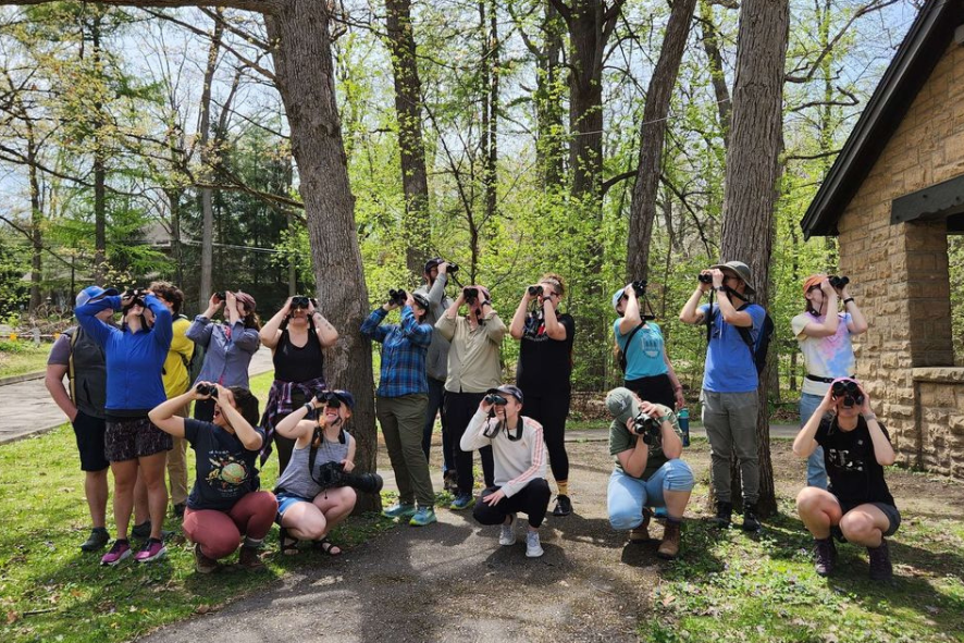 A group of people with binoculars