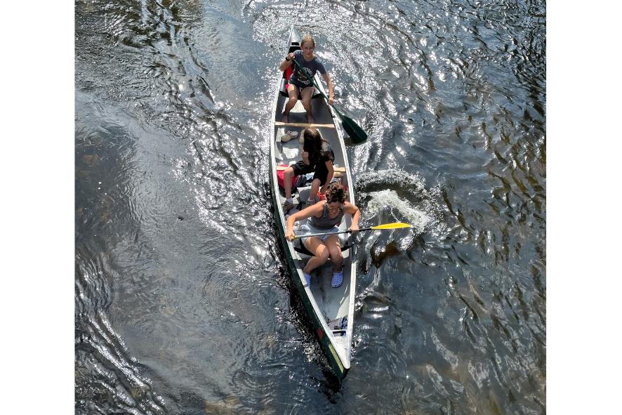 aeriel shot of kids in a canoe