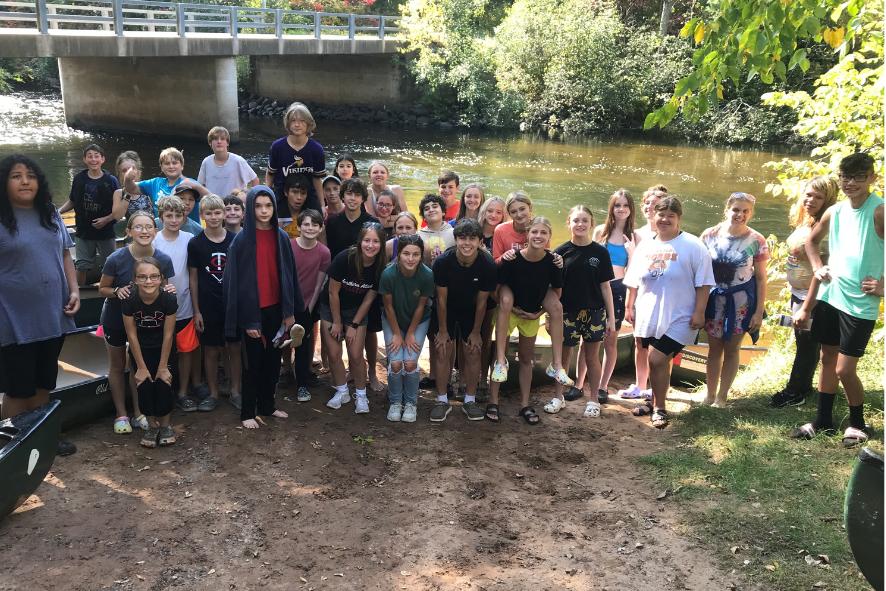 Students standing on the bank of the Namekagon River.