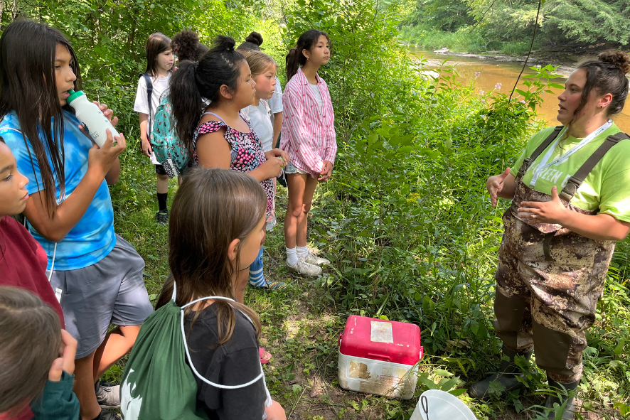 2023 grants for conservation feature - Students learn about aquatic invertebrates from Oneida Nation staff while on a hike