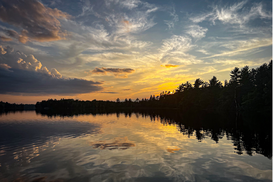 Sunset over a lake, with the sunset's reflection on the water